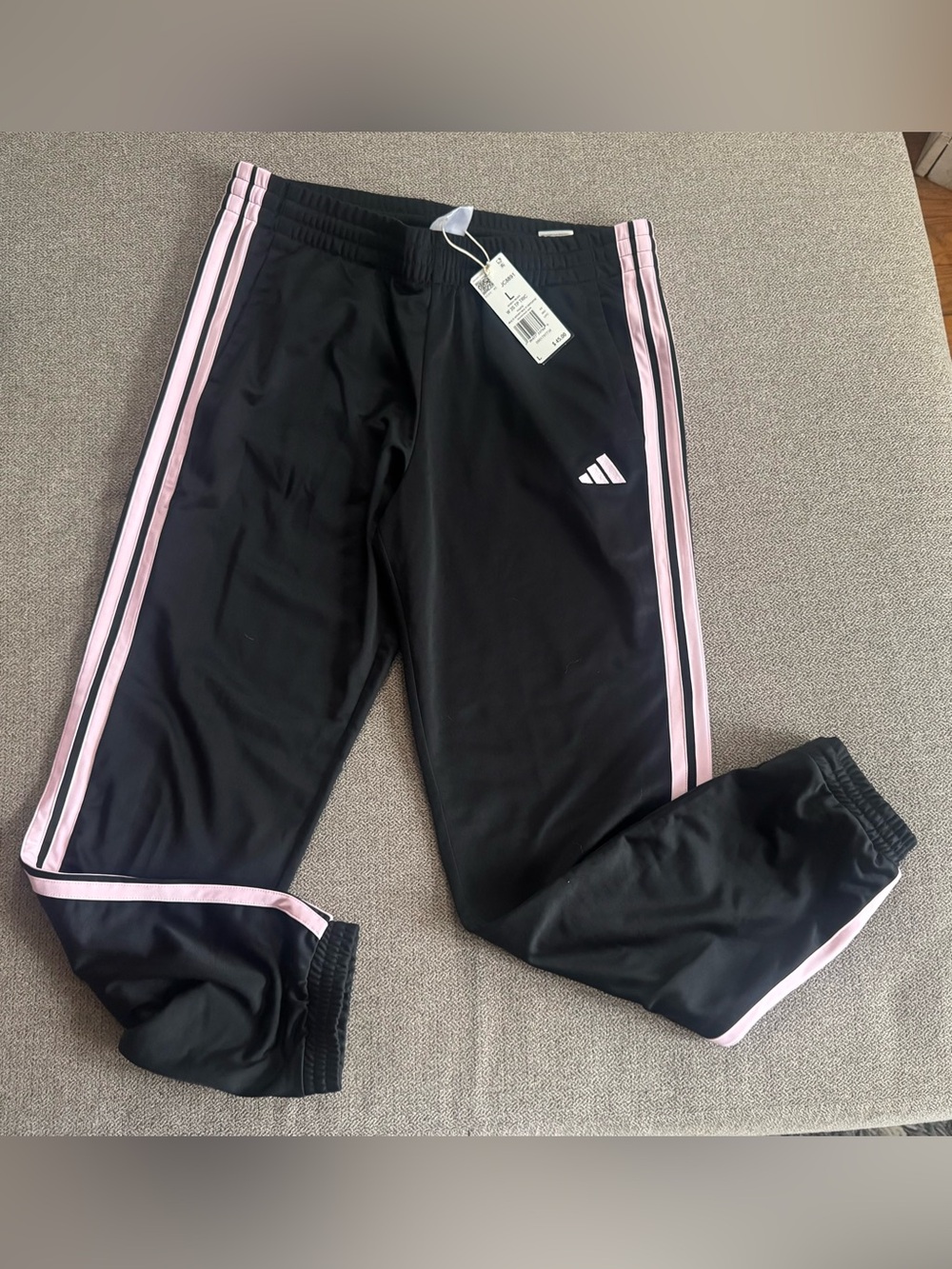 Women’s adidas track pants with pink logo